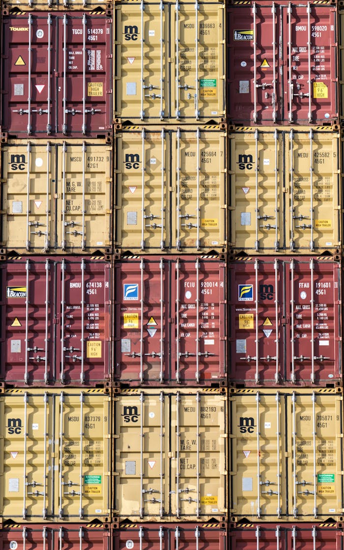 Mastering the First Impression: Your intriguing post title goes here Vertical stack of red and yellow shipping containers, illustrating global logistics.
