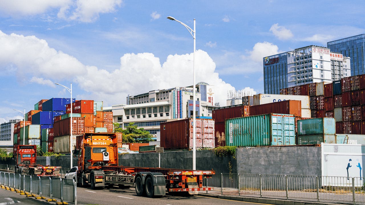 The Art of Drawing Readers In: Your attractive post title goes here Colorful shipping containers stack at an industrial port under clear skies.